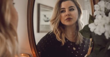 woman in black and white polka dot long sleeve shirt sitting on chair