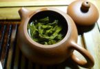 green leaves and clear liquid inside teapot