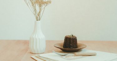 brown and black chocolate cake on white ceramic plate